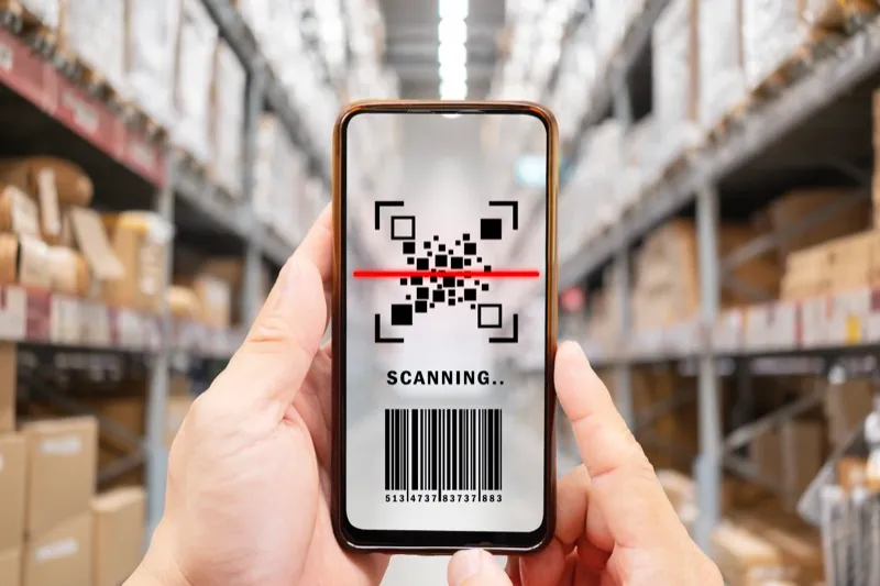 youngman using smartphone with qr code on product package box. e commerce market.
