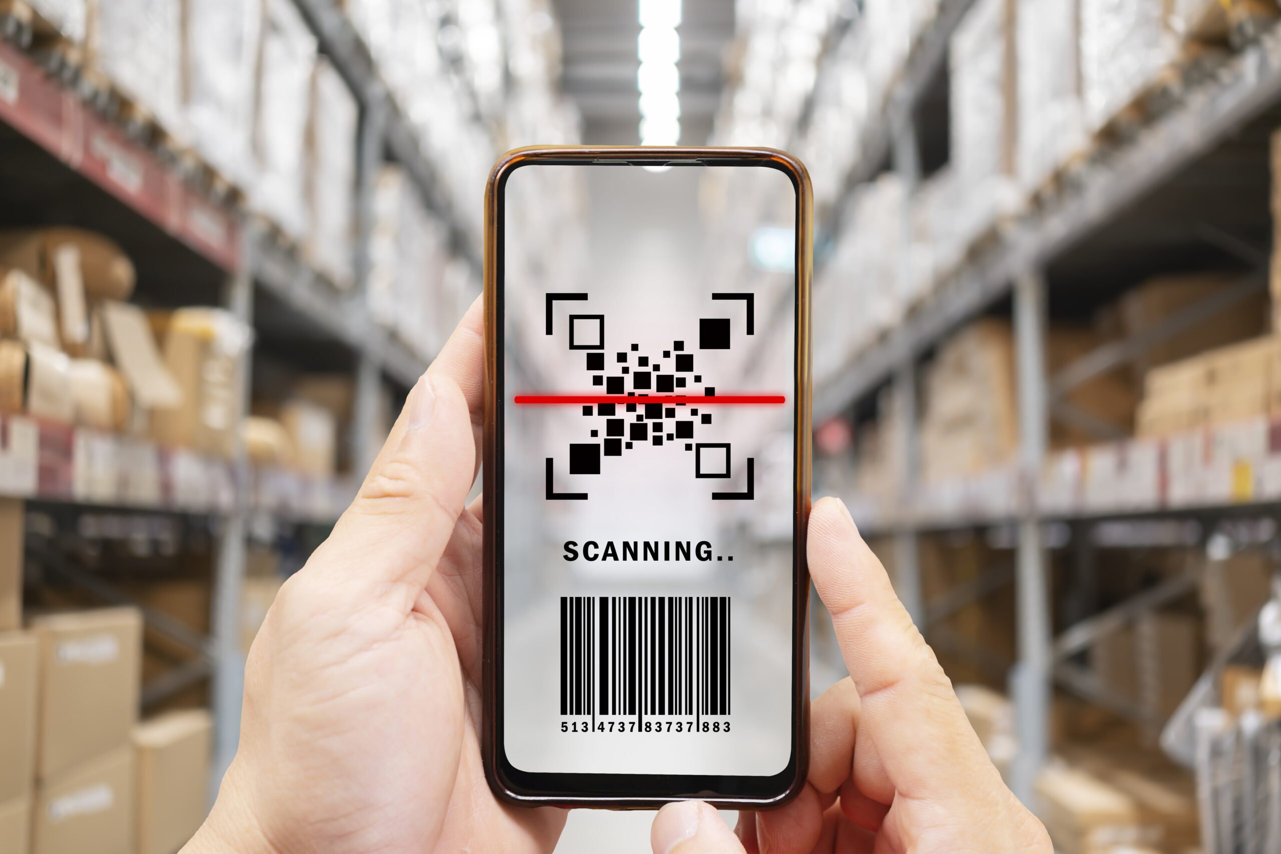 youngman using smartphone with qr code on product package box. e commerce market.