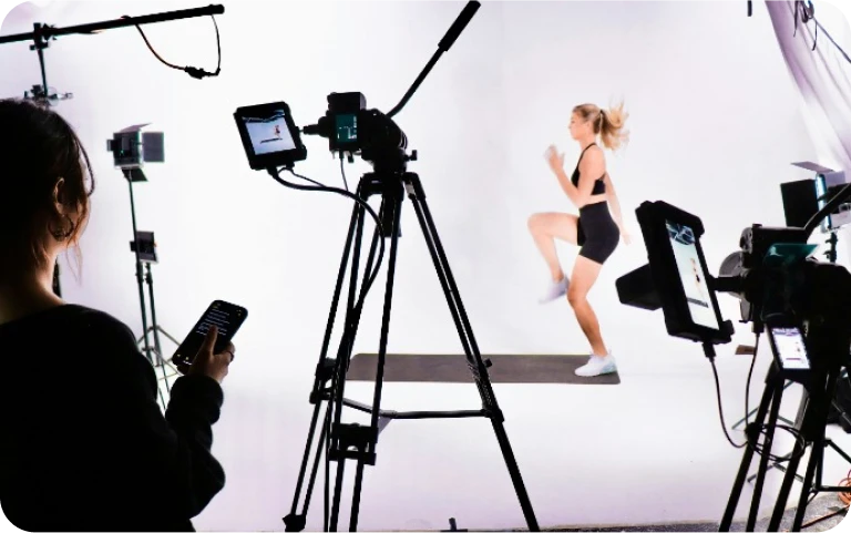 a woman standing in front of a camera