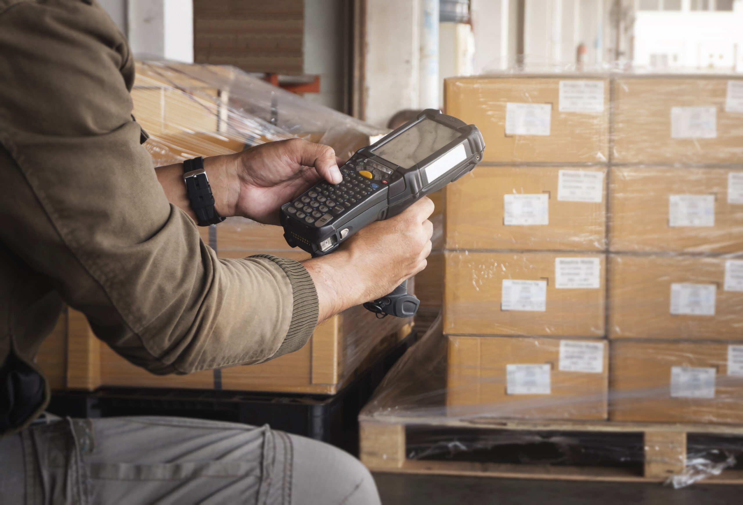 warehouse-worker-holding-barcode-scanner-storage-warehouse-computer-tools-inventory-management Strategies for Managing Obsolete Inventory