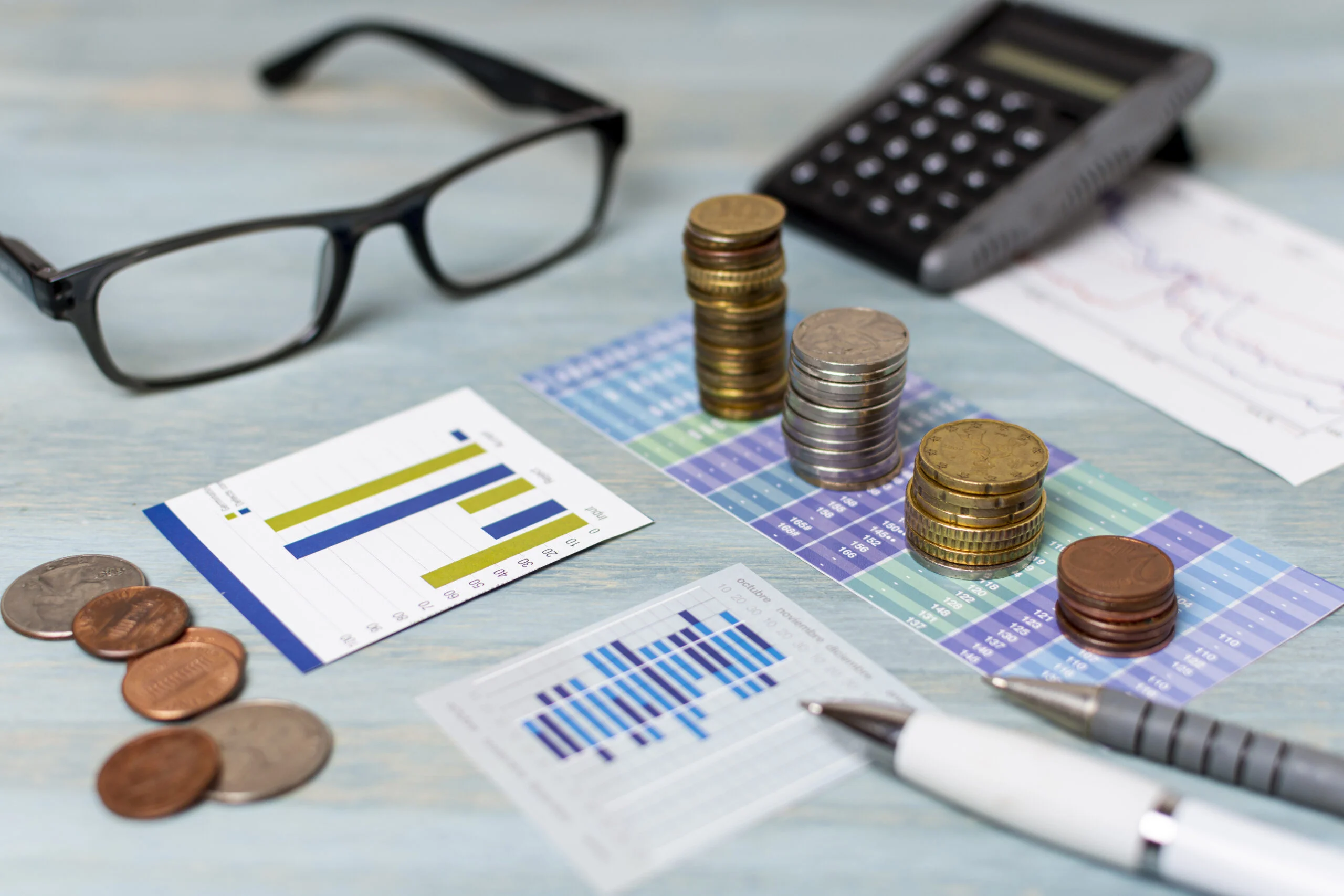 reading-glasses-piles-coins-high-view (1) What to Include in a Fixed Asset Register