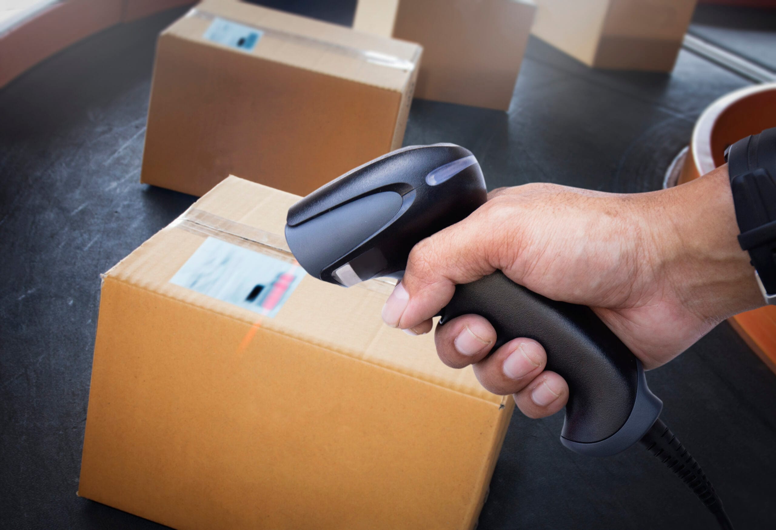worker-scanning-bar-code-scanner-package-boxes-computer-work-tools-inventory-management Indoor Tracking Solutions